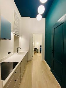 a kitchen with a sink and a blue wall at Kamienica Jagiellońska 27, 1 syp by VisitWarsaw Apartments in Warsaw