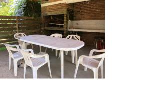 a white table and chairs on a patio at Chalet En La Paloma A 2 De Playa Los Botes (hermosa Zona) in La Paloma +12 photos