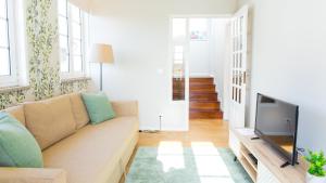 ein Wohnzimmer mit Couch und Flachbildfernseher in der Unterkunft Praça 44 in Braga