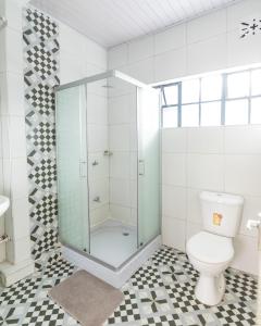 a bathroom with a shower and a toilet at Eldopalm Guesthouse in Eldoret