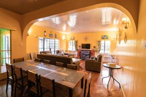 a dining room with a table and a living room at Eldopalm Guesthouse in Eldoret