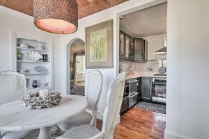 a kitchen with a white table and white chairs at Chincoteague Island Cottage about 2 Mi to Beaches in Chincoteague