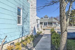 a wooden walkway next to a blue building at Chincoteague Island Cottage about 2 Mi to Beaches in Chincoteague
