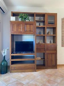 Televízia a/alebo spoločenská miestnosť v ubytovaní Casa Pasitea
