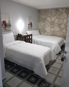 A bed or beds in a room at HOTEL CATARINA BAURU