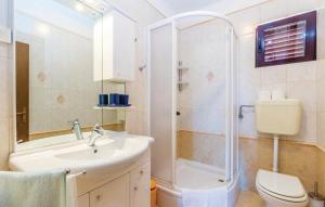 a bathroom with a sink and a shower and a toilet at Apartman Ivanka in Barbat na Rabu