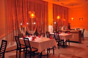 a dining room with white tables and chairs at Studio Villa Park 410 in Borovets