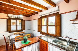 a kitchen with a sink and a table at Casa Sabina, Zona de playa y montaña in Llanes +30 photos