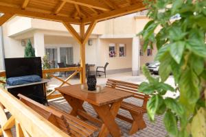 a patio with a wooden table and benches at Apartments Sejla in Ulcinj
