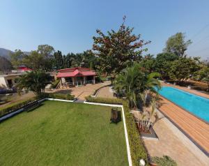 an aerial view of a yard with a swimming pool at Karjat retreat 4bhk pvt farmhouse in Karjat