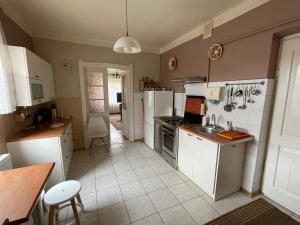 a kitchen with white cabinets and a counter top at Apartament in Bochnia