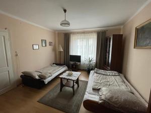 a living room with two beds and a table at Apartament in Bochnia