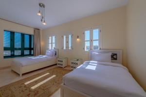 A bed or beds in a room at VESTA - El Gouna Residence