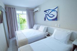 Tempat tidur dalam kamar di Hotel Rotorua inn Fortaleza - Beira Mar
