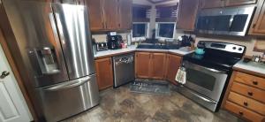 a kitchen with wooden cabinets and stainless steel appliances at Private Pet Friendly Home Near Exotic Deer Farm Close to Pigeon Forge, Gatlinburg TN in Sevierville