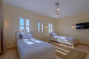 A bed or beds in a room at VESTA - El Gouna Residence