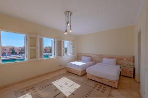 A bed or beds in a room at VESTA - El Gouna Residence