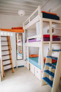 a room with four bunk beds and a mirror at Casa Caracol in Cádiz