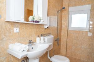 a bathroom with a sink and a toilet and a mirror at Apartments Sejla in Ulcinj