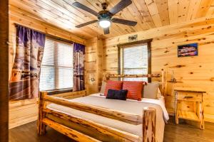 a bedroom with a bed in a log cabin at Route 66 Cabin in Pigeon Forge