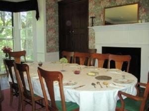 a dining room with a white table and chairs at Oak Grove Bed and Breakfast in South Boston