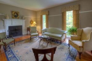 a living room filled with furniture and a fireplace at Oak Grove Bed and Breakfast in South Boston
