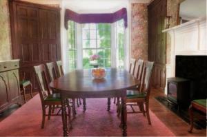 a dining room with a wooden table and chairs at Oak Grove Bed and Breakfast in South Boston