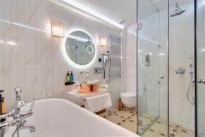 a bathroom with a shower and a toilet and a sink at ARCHONTARIKI Historic Boutique Hotel in Ioannina