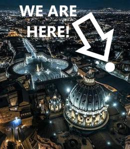 an image of a city at night with the words we are here at Vista San Pietro in Rome