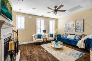 a living room with a blue couch and a fireplace at Luxury & Highly furnished upscale w Patio & Garage in Plano