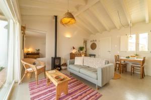 a living room with a couch and a table at Casinha da Cabra, Casas do Poente, Rogil, Aljezur in Aljezur +36 photos