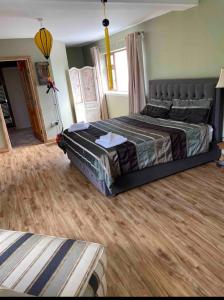 a bedroom with a bed and a wooden floor at Peaceful in Myshall