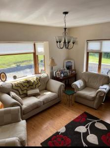 a living room with a couch and a table and windows at Peaceful in Myshall