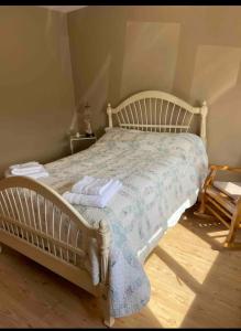 a bedroom with a white bed with a blue comforter at Peaceful in Myshall