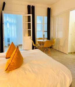 a large white bed with orange pillows in a room at Crops City Stay in Trieste