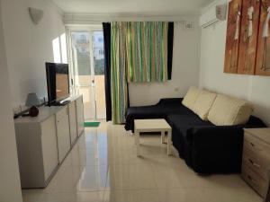 a small living room with a bed and a television at One Bed Room Apartment with terrace in Marsaskala