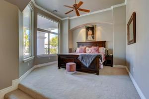 a bedroom with a bed and a ceiling fan at Villa del Sol, Amazing House by Kivoya in Tempe