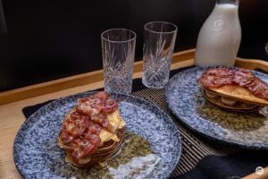 two plates of food on a table with pancakes at Flatmoen Natur Lodge in Alta