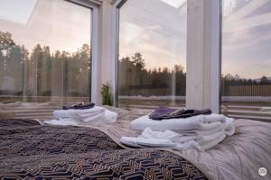 two beds with towels on them in front of a window at Flatmoen Natur Lodge in Alta +14 photos