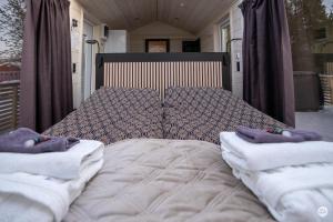 a bed with two pillows on top of it at Flatmoen Natur Lodge in Alta