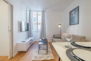 a living room with a couch and a table at SERRENDY NEW 1-bedroom apartment in the city center in Cannes