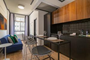 a kitchen with a table and chairs and a couch at BHomy Paulista Na Av Paulista com design BA608 in São Paulo