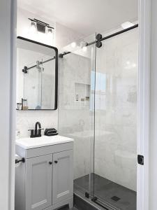 a bathroom with a sink and a glass shower at Malibu Private Beach Apartments in Malibu +133 photos