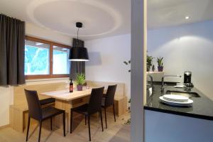 a kitchen and dining room with a table and chairs at Die Monika Aparthotel in Gaschurn