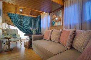 a living room with a couch and a window at ARCHONTARIKI Historic Boutique Hotel in Ioannina