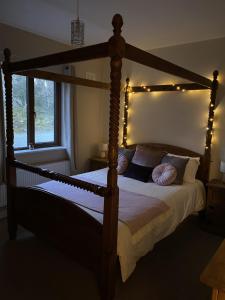 Un dormitorio con una cama de madera con luces. en Secluded hilltop hideaway! en Westport
