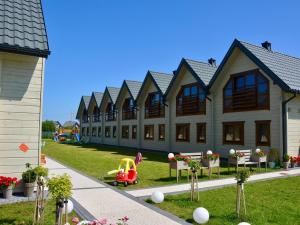 a building with a playground in front of it at Terraced Houses, Grzybowo in Grzybowo