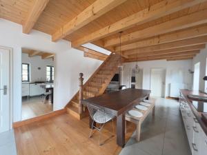 a dining room with a wooden table and chairs at Historisches Pastorat - Villa Mika in Fehmarn
