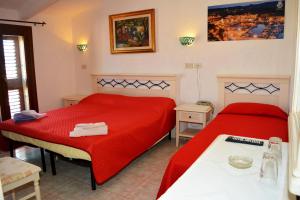 Säng eller sängar i ett rum på Gallura Hotel