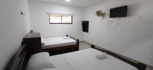 Giường trong phòng chung tại Hotel Tamaca Real